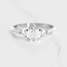 a white gold engagement ring with three diamonds