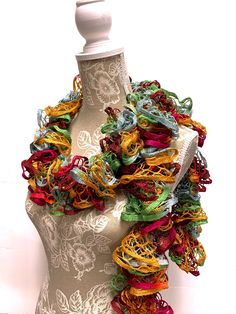 a mannequin is adorned with multicolored scarves