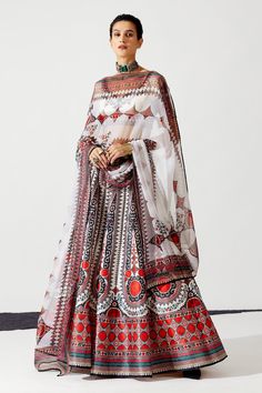 Ivory, red can-can and lined lehenga with geometric and floral print. Paired with printed blouse and printed dupatta.
Component: 3
Pattern: Printed
Type Of Work: Floral
Neckline: V Neck
Sleeve Type: Short Sleeves
Fabric: Blouse - Lycra, Dupatta - Kota Silk, Lehenga - Dupion 
Color: Ivory
Other Details: 
Geometric and floral print
Printed dupatta
Beaded borders
Back tassel tie-up
Occasion: Destination Wedding,Sangeet - Aza Fashions Ready To Wear Lehenga, Rajdeep Ranawat, Bridal Lehenga Online, White Lehenga, Printed Lehenga, Choli Blouse, Ivory Blouse, Salwar Dress, Dress Salwar Kameez