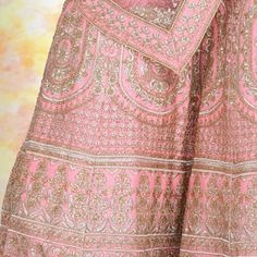 Looking for an elegant and traditional pink bridal lehenga for your wedding day? Look no further than this beautiful piece, made with luxurious silk and finished with gorgeous temple border embroidery on the dupatta and beautiful henna design embroidery on the lehenga. The entire piece is adorned with diamond work, making it truly special and perfect for your big day. You'll feel like a royal princess in this lovely lehenga! Pink Chandbali Choli For Eid, Pink Sharara For Navratri, Pink Sharara For Reception Navratri, Pink Sharara For Reception And Navratri, Pink Raw Silk Anarkali Set For Navratri, Pink Sharara With Dori Work For Reception, Traditional Pink Anarkali Set For Reception, Pink Sharara For Wedding And Navratri, Pink Raw Silk Sharara For Navratri