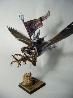 a figurine of an eagle with a flag on it's back