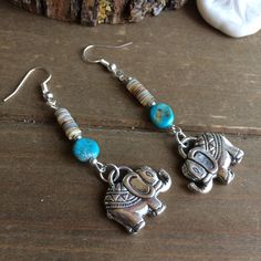 Elephant earrings puka shell earrings beach long earrings rare kabibi earrings surf dangle tropical turquoise boho earrings silver jewelry for women SLD. Length: 2 inches These beauties have 20mm antique gold elephant pendants, 5mm heishi rare kabibi oyster shell puka beads, 8mm campsitos North American turquoise genuine stone, silver plated findings and ear wires. Unique boho earrings from SLDbeadwork. Earrings for women. Yes, please. I love to rock a great pair of earrings. Stone, crystal, lam Bohemian Blue Shell Jewelry, Ocean-inspired Turquoise Shell Jewelry, Bohemian Shell-shaped Jewelry With Colorful Beads, Blue Shell-shaped Earrings For Beach, Gold Elephant Pendant, Bohemian Turquoise Shell-shaped Jewelry, Gold Elephant, Elephant Earrings, Stone Dangle Earrings