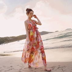 The Floral Printed Halter Neck Sleeveless Belted Maxi Dress boasts a vibrant floral pattern and a chic halter neckline. Its sleeveless design, accompanied by a matching belt, enhances the waistline, creating a graceful and summery silhouette perfect for various occasions. Pink Floral Print Sleeveless Dress For Beach, Pink Floral Print Sleeveless Dress For The Beach, Summer Sleeveless Floral Party Dress, Sleeveless Summer Floral Dress For Party, Sleeveless Summer Floral Party Dress, Multicolor Maxi Halter Dress For Spring, Spring Multicolor Maxi Halter Dress, Multicolor Spring Halter Maxi Dress, Orange Halter Neck Sleeveless Dress For Summer