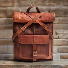 Handmade Genuine Leather Backpack Custom Engraved Rucksack Unisex style Travel Bag Laptop Bag Birthday Gifts, Graduation Gifts, Gifts for Him / Her, Monogram Leather Roll Top Bag Christmas Gift  Specifics:  Size - 23 inch x 14 inch x 5 inch  Colour -Brown  Closure - Push Locks Features: -1 Large Front Pocket - 2 Padded Partitions inside - Inner Zipper Pocket - Padded Compartment for Laptop Fits up to 17.3" - Spacious Main Compartment - Pen Loops  - Phone Pocket - Top Handle - Soft Padded Shoulde Vintage Rectangular Backpack With Adjustable Strap, Travel Satchel Backpack, Rectangular Backpack For Trips, Vintage Large Capacity Standard Backpack, Leather Travel Backpack With Large Capacity, Vintage Rectangular Leather Backpack For On-the-go, Rectangular Backpack With Adjustable Strap, Large Capacity Backpack For Travel, Large Capacity Rectangular Backpack For Travel