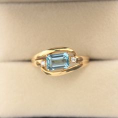 an aqua and diamond ring in a box