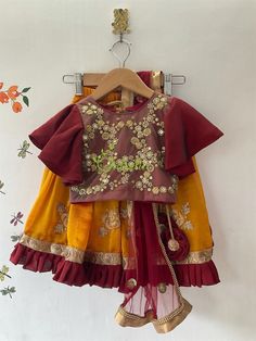 This ethnic lehenga featuring cape sleeve and jerry worked choli and tutu edged skirt accompanied with a sequienced dupatta. Please Visit My Shop For More Unique Collection https://www.etsy.com/shop/Chitralie BUYER'S PLEASE LEAVE YOUR CONTACT NUMBER. It's necessary for shipping. Fabric and Work Choli: Cape sleeve with jerry and sequence embroidered tulle fabric. The choli is lined in soft cotton fabric and ties at the back. The hanging is made with unique fabric flowers. Skirt: Gathered shimmer Diwali Traditional Wear With Zari Work And Cape Sleeves, Traditional Wear With Cape Sleeves For Navratri, Traditional Dress With Cape Sleeves For Festive Occasions, Traditional Festive Dress With Cape Sleeves, Embroidered Lehenga For Celebrations, Festival Choli With Zari Work And Cape Sleeves, Festive Anarkali Skirt Set With Traditional Drape, Embroidered Lehenga With Traditional Drape For Celebration, Festive Choli With Resham Embroidery For Celebrations