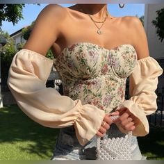 Brand New In Bag Cropped Off-Shoulder Floral Bustier With Flounce Sleeve Size: Small Or 4 Model Is Wearing: S(Us4) Height: 170cm / 66.9inch Bust: 82cm / 32.3inch Waist: 65cm / 25.6inch Hips: 91cm / 35.8inch Details: Boho Floral Off The Shoulder With Long Sleeves, Asymmetrical, Zipper Flounce Sleeve, Cropped Style, Slim Fit Non-Stretch, Woven Fabric Material: 100% Polyester Please See Photos For Condition All Reasonable Offers Will Be Considered Sales Tax May Apply Depending On Your Location Usa Spring Beige Corset With Built-in Bra, Beige Corset With Built-in Bra For Spring, Spring Off-shoulder Fitted Corset, Fitted Beige Top With Boned Bodice, Fitted Crop Top For Brunch In Fall, Fitted Crop Top For Fall Brunch, Trendy Summer Tops With Boned Bodice, Spring Crop Top With Boned Bodice, Spring Cropped Corset With Boned Bodice