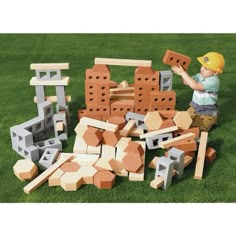 a child playing with blocks and bricks in the grass