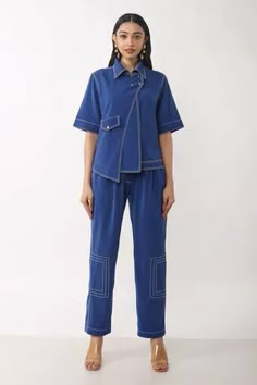 Blue crepe shirt featuring overlap detailing, metal rivets, a flap pocket, and a front zipper. Paired with matching pants that complement the shirt's design., Fit: Relaxed Co Ords Outfits, Coord Sets, Illustration Art Design, Cord Set, Coord Set, Western Tops, Contrast Piping, Blouse For Women, Pant Sets