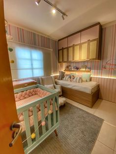 a baby's room with a crib in the corner and a bed on the other side