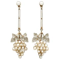 An impressive pair of antique Victorian seed pearl and 15k yellow gold, 9k yellow gold and platinum set drop earrings; part of our diverse antique jewellery collections These fine and impressive antique pearl earrings have been crafted in 15k and 9k yellow gold with platinum settings. Each drop earring has a bunched grape design, the grapes represented by a total of thirty-six natural seed pearls. Each bunch is ornamented to the upper border with a platinum set paired leaf design, and suspends f Luxury Victorian Style Clip-on Earrings, Antique Gold Set, Victorian Earrings Antiques, Victorian Drop Earrings, Art Deco Drop Earrings, Cluster Jewelry, Grape Design, Natural Pearl Earrings, Victorian Earrings