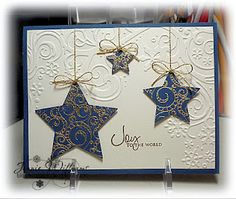 two blue stars hanging from strings on a card