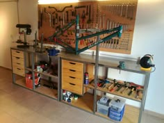 a workbench with lots of tools on it and some drawers below the shelf