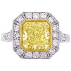 From the master jewelers at Pampillonia, this handmade fancy yellow diamond ring. The ring features a vibrate fancy yellow radiant cut diamond, SI1 clarity weighing 2.31 carats framed by 20 brilliant diamonds weighing .52 carats. G I A report. Yellow Platinum Diamond Ring, Yellow Platinum Diamond Ring Fine Jewelry, Fine Jewelry Yellow Diamond Platinum Ring, Yellow Diamond Platinum Ring With Center Stone, Dazzling Yellow Brilliant Cut Diamond Ring, Yellow Platinum Diamond Ring With Diamond Cut, Dazzling Brilliant Cut Yellow Diamond Ring, Yellow Diamond Cut Platinum Ring, Yellow Platinum Rings With Diamond Accents