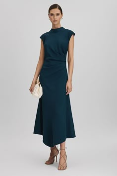 Find REISS Jessa Ruched Midi Dress on Editorialist. Engineered with stretch to hug the waist, this midi dress is cut with a high neckline, cap sleeves, and a ruched side. It zips close and features an oversized tie element to the back of the neck. High neckline Cap sleeves Ruche detailing Zip closure to reverse Tie back Midi length Donna Suits, Teal Outfits, Studded Mini Dress, Midi Wedding Dress, Gamine Style, Beautiful Dresses For Women, Ruched Midi Dress, Oversized Dress, Gowns Of Elegance