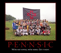 a group of people posing for a photo in front of a sign that says pennnsic