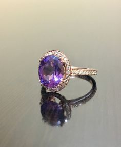 DeKara Designs Collection Our latest design! An elegant and lustrous Amethyst surrounded by beautiful diamonds in a halo setting. Metal- 18K Rose Gold, .750. Stones- Center Features a Oval Fiery Amethyst, 11 MM Long, 9 MM Wide, 44 Round Diamonds, G-H Color VS2-SI1 Clarity, 0.35 Carats. Latest of my creations. A beautiful 18K Rose Gold Amethyst Halo Diamond Ring. The Amethyst is professionally prong set in between 4 double prongs. There are 10 pave set round diamonds on each side of the shank and Luxury Rose Gold Amethyst Ring, Elegant Amethyst Wedding Ring, Elegant Wedding Amethyst Ring, Luxury Purple Amethyst Ring With Halo Setting, Purple Sapphire Ring With Halo Setting, Exquisite Oval Amethyst Ring For Wedding, Fine Jewelry Amethyst Halo Ring Gift, Exquisite Oval Amethyst Wedding Ring, Exquisite Amethyst Ring For Anniversary