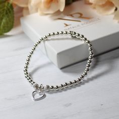 Sterling Silver Beaded Stacking Bracelet with Hollow Heart Charm Perfect gift for her/Ladies bracelet/bridal jewellery/Bridesmaid gift This beautiful bracelet is: handmade with 4mm Sterling silver round beads and two 5mm sterling silver corrugated beads and added hollow heart charm. Bracelets are made using durable jewellery elastic to an approximate length of 19cm. Should you require a bespoke size, please don't hesitate to contact me, Your jewellery comes packaged in a Natalie Rochelle gift box. Hollow Heart, Minimalist Bracelet, Online Jewelry Store, Sterling Silver Heart, Heart Bracelet, Heart Charm Bracelet, Bracelet Stack, Sterling Silver Bead, Silver Heart