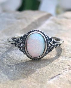 Sterling Silver Oval White Lab Opal Ring | The Life Divine Sterling Silver Oval White Lab Opal RingCherished for its brilliance, Opal is known as a stone of creativity and vitality. Opal is also a reflective stone of protection, absorbing energies and sending them back to their source.Measures approximately 3/8" H x 1/2" W Spiritual Oval Crystal Ring With Stone Setting, Adjustable White Oval Crystal Ring, Spiritual Oval Opal Promise Ring, Silver Opal Ring With Large Oval Stone, Silver Oval Opal Ring With Large Stone, Adjustable Oval Opal Ring With Large Stone, Spiritual White Oval Opal Ring, Adjustable Opal Crystal Ring, Oval Shape, Adjustable Opal Oval Crystal Ring