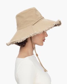 Women's elegant canvas sunhat for sale online, features a fringed edge and adjustable chin strap, which will secure it on the windiest of days. This soft, floppy hat is lightweight, breathable and provides complete coverage for your face, neck and ears. Soft, lightweight and packable. Rolls and folds into a tote bag. Brim span: 4.5" Adjustable chin strap. Durable 12 oz canvas 50+ UPF rating for the best in sun protection Blocks 98% of UVA/UVB rays Dry clean only. Adjustable Fringe Hat With Curved Brim, Casual Sun Hat With Fringe, Casual Hats With Fringe And Curved Brim, Adjustable Fringe Hat For Spring, Casual Sun Hat With Fringe And Curved Brim, Adjustable Fringe Hats, Spring Brimmed Hat With Fringe, Wide Brim Sun Hat With Fringe, Casual Adjustable Sun Hat With Fringe