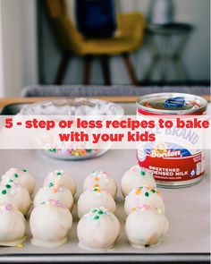 some cake balls are on a pan with sprinkles and a can of food in the background