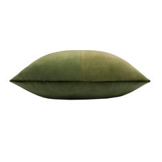 a green pillow sitting on top of a white surface