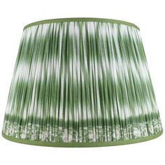 a green and white lamp shade with pleated fabric on the bottom, hanging from a ceiling fixture