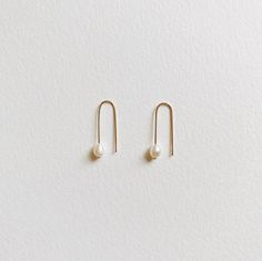 + PEARL U HOOP THREADER EARRINGS +Tiny Fresh Water pearl threader in U shape made with 14k Gold-filled wires. A small drop dangle on your ears that are modern & classic. + Fresh water pearls 4mm+ 14k Gold-filled wire+ Listing is for 1 pair of earrings+ Please allow 5-7 business days to ship out. Minimalist White Pearl Earrings In 14k Gold Filled, Minimalist White Pearl Earrings 14k Gold Filled, Minimalist 14k Gold Filled Pearl Earrings For Gift, Minimalist White 14k Gold Filled Pearl Earrings, Minimalist 14k Gold Pearl Drop Earrings, Minimalist Dangle Threader Earrings With Pearl Charm, Minimalist Pearl Earrings For Everyday, Everyday White Threader Earrings, Minimalist 14k Gold Filled Earrings With Pearl Charm