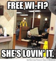 a man standing in front of a mcdonald's restaurant with his computer on the counter