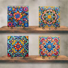 three wooden shelves with colorful tile designs on them, one is painted and the other is made out of wood