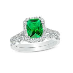 An eye-catching style, this vintage-inspired bridal set matches your bold romance. Crafted in sterling silver, the colorful engagement ring showcases an 8.0 x 6.0mm cushion-cut lab-created verdant-green emerald wrapped in a frame of shimmering petite diamonds - all set atop a glimmering diamond-lined shank. On your wedding day, complete her look with the coordinating band that features a row of alternating marquise-shaped and round frames adorned with sparkling petite diamonds and intricate milg Classic Emerald Ring With Diamond Accents For Wedding, Fine Jewelry Halo Setting For Wedding, Wedding Fine Jewelry With Halo Setting, Silver Princess Cut Emerald Ring For Wedding, Dazzling Emerald Ring With Diamond Accents For Wedding, Dazzling Silver Emerald Ring For Wedding, Dazzling Silver Emerald Wedding Ring, Dazzling White Gold Emerald Ring For Wedding, Dazzling Cubic Zirconia Ring For Wedding