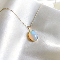 This stunning Pendant is set in 14k Solid Yellow Gold with Natural Ethiopion Opal with utmost precision. It is a unique gemstone Pendant for nearly every occasion and is completely hassle-free jewelry. ITEM DETAILS: * GEM: Ethiopion Opal * GEM SIZE: 12x16mm * GEM SHAPE: Oval * Gem weight: 6.39 carats * Gold Purity: 14KT (58.33% approx.) * Gold Weight: 1.16 gram * Total Weight of the Pendant: 2.44 gram The Gold purity is guaranteed and it comes with authentic 14KT gold hallmark. Since my items are handmade, they are absolutely nickel and lead free. CUSTOMIZATION: * Gemstone customization is available and it can be substituted with a gem of your choice. Kindly message me for the same. PACKAGING * The Pendant comes with layers of safe and secure wrapping along with Free handmade jewelry box w Yellow Gold Opal Oval Pendant Jewelry, Elegant Ethiopian Opal Pendant Necklace, Heirloom Oval Ethiopian Opal Jewelry, Heirloom Ethiopian Opal Oval Jewelry, Fine Jewelry Wedding Necklace With Cabochon, Elegant Ethiopian Opal Cabochon Necklaces, Heirloom Opal Jewelry In Yellow Gold, Elegant Ethiopian Opal Oval Pendant Necklace, 14k Gold Birthstone Jewelry For Celebration