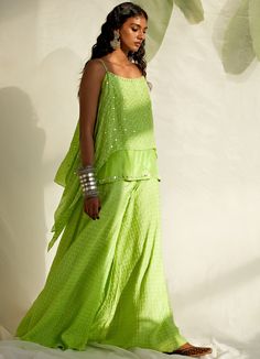 Channel your inner boho queen in this Lime Green Spaghetti double-layered short Bandhej kurta with mirror detailing teamed with matching Bandhej Sharara pants. Dupatta can be added at an additional cost Composition : Silk Care: Dry Clean Only and Vacuum Storage This product can be customised for sleeves, length of blouse and neckline Delivery : 4-6 weeks as the product is hand crafted. For more information and sizes please contact fabiliciousfashion@gmail.com or visit our Copenhagen studio.About Designer Wear Summer Sharara With Traditional Drape, Bohemian Sets With Mirror Work For Spring, Bohemian Spring Sets With Mirror Work, Spring Bohemian Sets With Mirror Work, Bollywood Style Sharara With Cutdana For Spring, Spring Sharara With Mirror Work In Chanderi, Sleeveless Summer Sets With Sheer Dupatta, Summer Sleeveless Sets With Sheer Dupatta, Summer Traditional Drape Palazzo Set With Gota Work