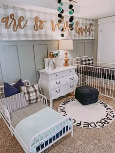 a baby's room with two cribs, a dresser and a bed