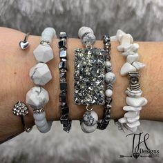 White, gray and silver beaded bracelet stack. Made with the gemstone bead Howlite. Beautiful stone which is good for calming and stress relief. Small-7" Medium-7.5" Large-8" Please measure your wrist to ensure correct size. Each bracelet is made to order so correct sizing is recommended before ordering. Using a fabric tape measure, measure just under your wristbone and choose the size closest to your exact measurement. How to care for your beaded bracelets: **Always put your bracelet on by rolling it over your hand without excessive pulling. Try not to stretch it over your hand. **Keep bracelets away from soap, perfumes, hair and skin care products, sunscreen, salt water etc... Many everyday products that we use can degrade the quality of the elastic over time. Adjustable Gray Bracelets With Faceted Beads, Adjustable Gray Bracelet With Faceted Beads, Gray Adjustable Bracelets With Faceted Beads, Adjustable Gray Gemstone Beads Bracelets, Adjustable Gray Gemstone Beads Bracelet, Adjustable Gray Beaded Bracelets With Natural Stones, Adjustable Gray Beaded Spiritual Bracelets, Adjustable Gray Stretch Bracelet For Gift, Adjustable Gray Stretch Bracelet Gift