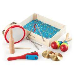 an assortment of wooden toys including drum, mallets and other items on a white background