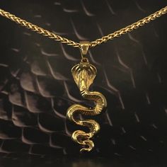 This is a Cobra necklace, a handmade jewelry. This unisex necklace is the perfect gift for him and her any time of the year  Immerse yourself in the mystical world and discover your inner power with our handmade cobra pendant necklace. Inspired by the sacred serpent, this handmade pendant invites you to explore spirituality and awaken your inner strength. The cobra symbolizes transformation, rebirth, and ancient wisdom. Its presence evokes the energy of kundalini, a powerful life force that lies Spiritual Brass Jewelry In Snake Shape, Spiritual Brass Snake-shaped Jewelry, Symbolic Gold Snake Jewelry, Symbolic Snake-shaped Necklace For Gift, Symbolic Snake Necklace As A Gift, Symbolic Snake Shaped Necklace For Gift, Brass Snake-shaped Necklace For Gifts, Gold Snake-shaped Engraved Necklace, Gold Snake Necklace With Engraving