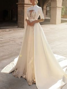 a woman in a wedding dress standing outside