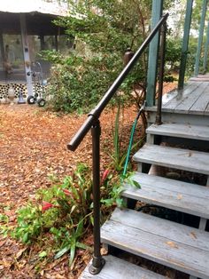 a set of stairs leading up to a house in the fall with leaves on the ground