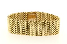 This chic woven linked bracelet is made in rich 14K Yellow gold. The piece is secured to the wrist via a box clasp and latch system. The bracelet measures 23mm wide, sits 2.48mm tall, and is of 7 inches in length.  B1848BIVPPD --Please reference our policy for more details before purchase--***For International orders, please provide a phone number for shipping purposes. Just place a note in the comment box during check out.Thank you.** Luxury Yellow Gold Chain Bracelet With Clasp, Luxury Chain Bracelet With Clasp For Formal Occasions, Elegant Gold Link Bracelet With Clasp, Luxury Chain Bracelet With Clasp For Formal Events, Elegant Gold Link Bracelet, Elegant Formal Chain Bracelet, Luxury Chain Bracelet With Box Clasp For Formal Occasions, Formal Gold Link Bracelet With Bracelet Strap, Luxury Chain Bracelet With Box Clasp For Formal Events