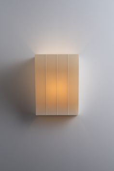 a square light fixture mounted on the wall