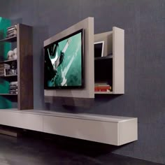 an entertainment center with a flat screen tv mounted on the wall