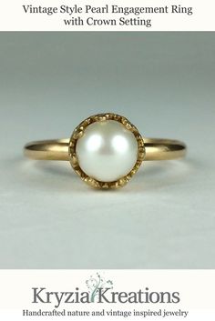 Vintage style pearl engagement ring in 14kt with a creamy white pearl sitting in a filigree heart-crown setting on a simple band of gold. Timeless Pearl White Pearl Ring For Anniversary, Timeless Pearl Ring For Anniversary, Timeless Pearl Ring For Anniversary With Round Band, Classic Gold Pearl Ring For Anniversary, Classic Pearl White Promise Ring, Timeless Solitaire Pearl Ring For Weddings, Timeless Wedding Rings With Pearl Drop, Classic Pearl Ring For Anniversary, Elegant White Gold Pearl Ring With Bezel Setting