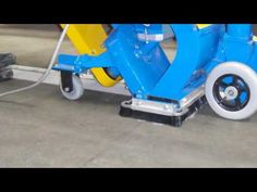 a blue and yellow scooter sitting on top of a parking lot