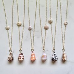 Long Cone Shell Necklaces~ Gorgeous big cone shells on 14k gold fill chain connecting with a puka shell. *Choose shell from the drop down menu. Each necklace varies in length ~ Shell #1 28" Shell #2 30" Shell #3 30" Shell #4 27" Shell #5 30" Shell #6 29" **Model wearing similar designs Shop~ http://www.etsy.com/shop/HanaMauiCreations?ref=pr_shop_more International buyers please read our shipping policies before ordering~ POLICIES~ https://www.etsy.com/shop/HanaMauiCreations/policy?ref=shopinfo_p Real Shell Jewelry, Limpet Shell Jewelry, Cone Shell Jewelry, Puka Shell Jewelry, Broken Shell Jewelry, Opihi Shell Jewelry, Small Shell Crafts, Surfer Girl Fashion, Shell Necklace Diy