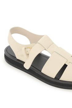 Composition: 100% Calfskin Leather Modern Leather T-strap Sandals For Spring, Designer Leather Slingback Sandals For Summer, Classic Closed Toe Sandals With Textured Sole, Beige Leather Flat Slingback Sandals, Beige Flat Leather Slingback Sandals, Beige Leather Flat T-strap Sandals, Spring Calf Leather Sandals With Rubber Sole, Designer Summer Calf Leather Sandals, Modern Closed Toe Sandals With Textured Sole