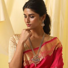 Description: A sculptural form of an antique necklace takes inspiration from the temples of India and translates it into a dressy pair to adorn. The hue of antique gold adds up a sparkle with the CZ stones along with the pearl drops at the base enhance the beauty of the piece. Making its presence felt with any outfit this one is worth making an on-trend statement. Details & Specifications: Materials used: Brass Alloy with Antique Plating Weight – Necklace 84 gm, Earrings 25 gm Length – Necklace Antique Long Necklace, Temples Of India, Long Necklace Set, Length Necklace, Antique Necklace, Gold Polish, Pearl Drop, Cz Stone, Jewelry Trends