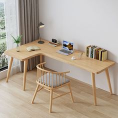 a wooden desk with a laptop on top of it next to a chair and window