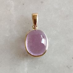 DESCRIPTION: This stunning Pendant is set in 14k Solid Yellow Gold with Natural Kunzite with utmost precision. It is a unique gemstone Pendant for nearly every occasion and is completely hassle-free jewelry. ITEM DETAILS: * GEM : Kunzite * GEM SIZE: 9X11mm * GEM SHAPE: Oval * Gem weight: 7.30 carats * Gold Purity: 14KT (58.33% approx.) * Gold Weight: 0.54gram * Total Weight of the Pendant: 2.00 gram The Gold purity is guaranteed and it comes with authentic 14KT gold hallmark. Since my items are handmade, they are absolutely nickel and lead free. CUSTOMIZATION: * Gemstone customization is available and it can be substituted with a gem of your choice. Kindly message me for the same. PACKAGING * The Pendant comes with layers of safe and secure wrapping along with Free handmade jewelry box wit Luxury Gold Oval Gemstones, Gold Jewelry With Large Oval Cabochon Stone, Oval 14k Gold Gemstones For Gift, Oval 14k Gold Gemstones As Gift, Elegant Cabochon Amethyst Gemstones, Elegant Amethyst Cabochon Gemstones, Yellow Gold Jewelry With Kunzite Gemstones, Gold Round Gemstones With Polished Finish, Round Gold Gemstones With Polished Finish