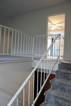 an empty room with stairs leading up to the second floor